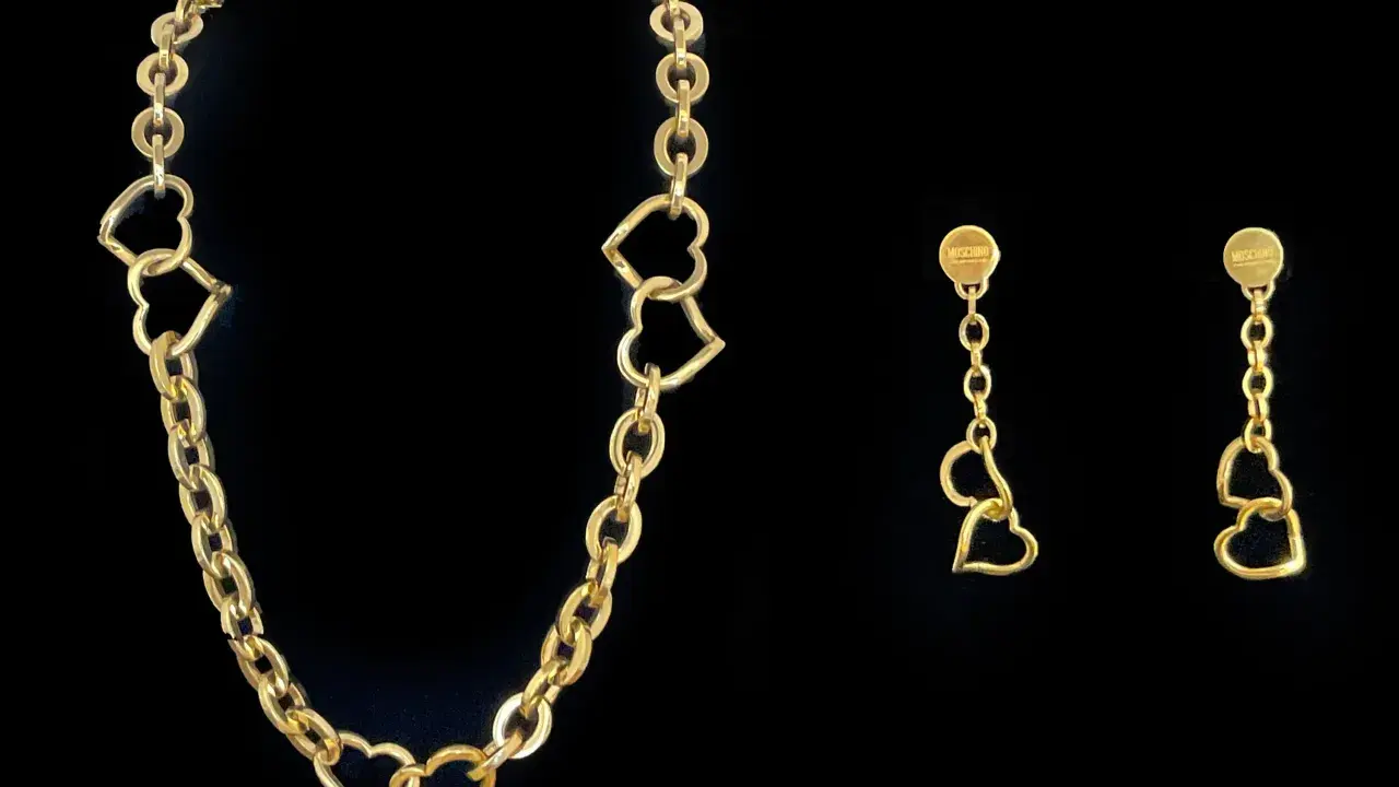 Collana Moschino in oro con cuori intrecciati e orecchini pendenti coordinati.