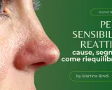 Primo piano di un viso con arrossamento evidente, indicativo di pelle sensibile. Il testo parla di pelle sensibile e reattiva.