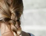 Capelli biondi intrecciati in una treccia. Per chi ha capelli grassi, la frequenza di lavaggio è una questione personale.