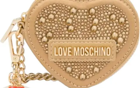 A beige heart-shaped Moschino keychain with gold studs and "LOVE MOSCHINO" logo.