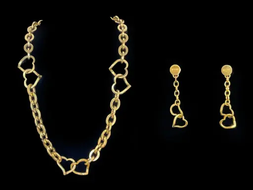 Collana Moschino in oro con cuori intrecciati e orecchini pendenti coordinati.