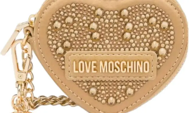 A beige heart-shaped Moschino keychain with gold studs and "LOVE MOSCHINO" logo.